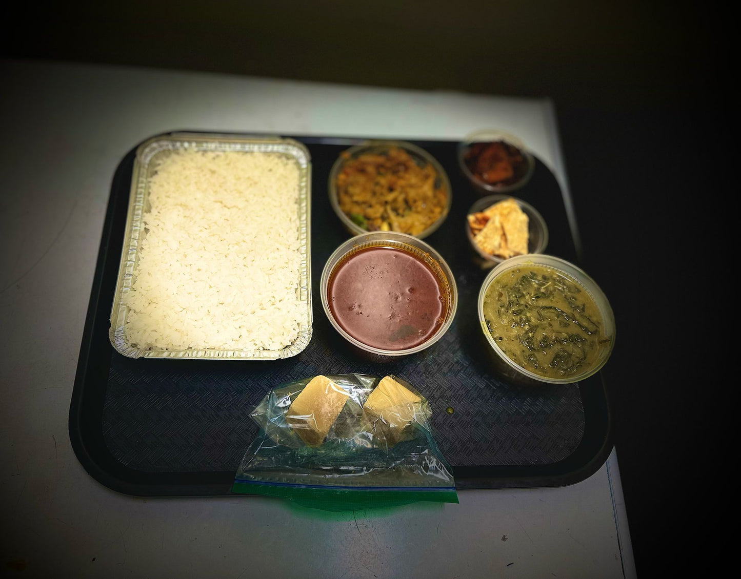 Tamilnadu style mini meals for Two People(Rice, Garlic (poondu) kuzhambu, Appala Kootu, Manathakkali Keerai Kootu, Vazhakka fry, Mysore pak)